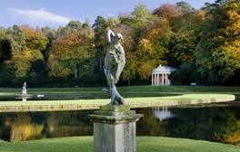 The lead statue of Bacchus in front of the Temple of Piety at Studley Royal Water Garden, North Yorkshire. The gardens were created in 1716 by John Aislabie and continued by his son William in the later eighteenth century.